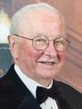 image of an older man with glasses wearing a tuxedo