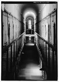 Black and white photograph of a penitentiary corridor