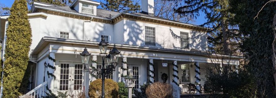 Brockamour Manor - A white house with lots of trees