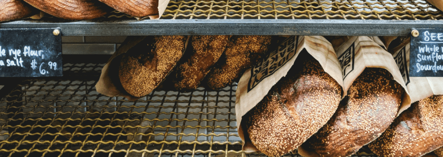 picture of breads on a shelf at a bakery